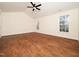 Spacious bedroom featuring gleaming hardwood floors and natural light from two windows at 9412 Harvest Acres Ct, Raleigh, NC 27617