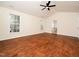 Large bedroom with hardwood floors, ceiling fan, and access to the ensuite bath at 9412 Harvest Acres Ct, Raleigh, NC 27617