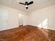 Bedroom features a ceiling fan, closet and hardwood floors at 9412 Harvest Acres Ct, Raleigh, NC 27617