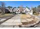 A collection of townhouses, each featuring attached garages, neat driveways, and well-maintained yards at 9412 Harvest Acres Ct, Raleigh, NC 27617