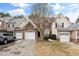Charming townhouse exterior featuring attached garages and a neat driveway, blending convenience with curb appeal at 9412 Harvest Acres Ct, Raleigh, NC 27617