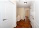 Hallway featuring hardwood floor, white doors and neutral-colored walls at 9412 Harvest Acres Ct, Raleigh, NC 27617