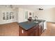 This modern kitchen features a granite countertop island, stainless steel appliances, and an open layout to the living space at 9412 Harvest Acres Ct, Raleigh, NC 27617