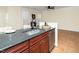 Charming kitchen showcasing stainless steel appliances, a granite countertop island, and open layout to the living area at 9412 Harvest Acres Ct, Raleigh, NC 27617