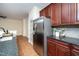 Well-appointed kitchen features stainless steel refrigerator, granite countertops, and dark wood cabinetry at 9412 Harvest Acres Ct, Raleigh, NC 27617