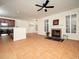 Bright living room boasts recessed lighting, neutral walls, tile floors, fireplace, and large windows with plantation shutters at 9412 Harvest Acres Ct, Raleigh, NC 27617