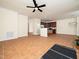 Open living area with tile flooring, ceiling fan, and access to kitchen; perfect for entertaining at 9412 Harvest Acres Ct, Raleigh, NC 27617