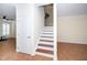 Stairway with wood treads and white risers complements the open living space at 9412 Harvest Acres Ct, Raleigh, NC 27617