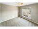 Well-lit bedroom with neutral carpeting and large window at 1012 Fulbright Dr, Morrisville, NC 27560