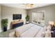 Comfortable bedroom with large window and ceiling fan at 1012 Fulbright Dr, Morrisville, NC 27560