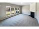 Living room with fireplace and large windows overlooking backyard at 1012 Fulbright Dr, Morrisville, NC 27560