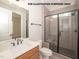Modern bathroom with tiled shower, wood vanity, and modern fixtures at 1021 Smoke Willow Way # 130, Rolesville, NC 27571