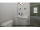 Modern bathroom featuring a white vanity with a black faucet, complemented by a sleek mirror and neutral-toned walls at 1021 Smoke Willow Way # 130, Rolesville, NC 27571