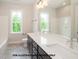 Bright bathroom featuring a double vanity, large mirror, and tiled floors, combining style and functionality at 1021 Smoke Willow Way # 130, Rolesville, NC 27571