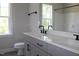 Modern bathroom with double sink vanity, light gray cabinets, and a large mirror at 1021 Smoke Willow Way # 130, Rolesville, NC 27571