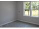 Bright bedroom featuring a window offering a view of the outdoor greenery at 1021 Smoke Willow Way # 130, Rolesville, NC 27571