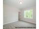 Bright bedroom with neutral walls, carpet flooring, and a window that provides natural light and a view of the outdoors at 1021 Smoke Willow Way # 130, Rolesville, NC 27571
