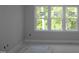 Bedroom featuring three large windows that flood the space with natural light and offer serene outdoor views at 1021 Smoke Willow Way # 130, Rolesville, NC 27571