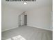 Cozy bedroom showcasing neutral walls, plush carpet, and entry to the living space at 1021 Smoke Willow Way # 130, Rolesville, NC 27571
