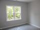 Bright bedroom featuring a window offering a view of the outdoor greenery at 1021 Smoke Willow Way # 130, Rolesville, NC 27571