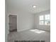 Bright bedroom with neutral walls, carpet flooring, closet access, and natural light at 1021 Smoke Willow Way # 130, Rolesville, NC 27571