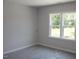 Bright bedroom featuring a window offering a view of the outdoor greenery at 1021 Smoke Willow Way # 130, Rolesville, NC 27571