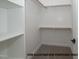 Walk-in closet with built-in shelving and rods, providing ample storage space in a well-organized design at 1021 Smoke Willow Way # 130, Rolesville, NC 27571