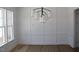 Dining room with modern light fixture and wainscotting at 1021 Smoke Willow Way # 130, Rolesville, NC 27571