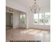 Elegant dining room with detailed trimwork, a stylish chandelier, and natural light from large windows at 1021 Smoke Willow Way # 130, Rolesville, NC 27571