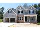 Charming two-story home with a two-car garage, brick accents, and a covered front porch at 1021 Smoke Willow Way # 130, Rolesville, NC 27571
