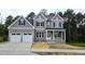 Charming two-story home with a two car garage, dark shutters, and covered front porch at 1021 Smoke Willow Way # 130, Rolesville, NC 27571