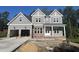 New construction two-story home featuring a brick base, neutral siding, three gables, and an attached two-car garage at 1021 Smoke Willow Way # 130, Rolesville, NC 27571
