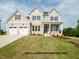 Charming two-story home featuring three-car garage, neutral siding, manicured lawn, and tasteful landscaping at 1021 Smoke Willow Way # 130, Rolesville, NC 27571