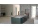 Unfinished kitchen featuring a dark green kitchen island and modern gray cabinets, awaiting countertops at 1021 Smoke Willow Way # 130, Rolesville, NC 27571