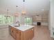 Spacious open-concept kitchen flows into the living area with a central island and modern fixtures at 1021 Smoke Willow Way # 130, Rolesville, NC 27571