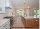 Well-designed kitchen with stainless steel appliances, a central island, and an open view into a dining area at 1021 Smoke Willow Way # 130, Rolesville, NC 27571