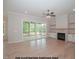 Bright living room with built-in shelving, a fireplace, and large glass doors leading to an outdoor space at 1021 Smoke Willow Way # 130, Rolesville, NC 27571
