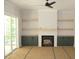 Living room with a fireplace, built-in cabinets and shelves, and slider access to the outside at 1021 Smoke Willow Way # 130, Rolesville, NC 27571