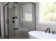 Main bathroom with glass enclosed shower, soaking tub, and neutral finishes at 1021 Smoke Willow Way # 130, Rolesville, NC 27571