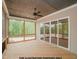 Covered porch with wood floors, ceiling fan and screened walls overlooking a wooded view at 1021 Smoke Willow Way # 130, Rolesville, NC 27571