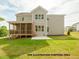 Exterior view showcasing the back of the home with a large screened porch and backyard at 1021 Smoke Willow Way # 130, Rolesville, NC 27571