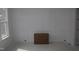 A room with white wainscoting on the walls and a large window, awaiting final touches and furnishings at 1021 Smoke Willow Way # 130, Rolesville, NC 27571