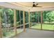 Enjoy outdoor living on this screened porch with wooded views and a ceiling fan at 1021 Smoke Willow Way # 130, Rolesville, NC 27571