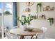 Dining area with round table, floating shelves and a large window at 104 Kobus Ct, Garner, NC 27529