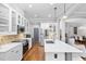 Modern kitchen with white cabinets, large island, and stainless steel appliances at 107 Sunstone Dr, Cary, NC 27519