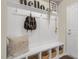 White entryway bench with storage and hooks at 120 Kobus Ct, Garner, NC 27529