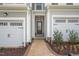 Townhome entry with brick walkway and double garage at 120 Kobus Ct, Garner, NC 27529