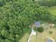 Aerial view of a secluded home surrounded by lush green trees, creating a private and serene setting at 1610 Woodards Dairy Rd, Middlesex, NC 27557