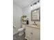 Well-lit bathroom featuring a vanity with granite countertops and a decorative mirror at 1610 Woodards Dairy Rd, Middlesex, NC 27557