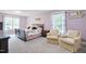 Spacious bedroom with two armchairs and a large bed at 1610 Woodards Dairy Rd, Middlesex, NC 27557